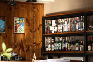 a shelf filled with lots of bottles of alcohol at Alpine Lounge Kazbegi in Stepantsminda