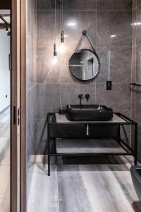 a bathroom with a black sink and a mirror at Valletta Stylish 2 Beds Flat in Valletta