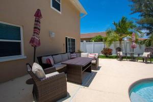 a patio with a couch and chairs and a table at Beach and Pool, what more do you need? in Clearwater Beach