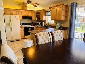 a kitchen with a table and chairs and a refrigerator at Beach and Pool, what more do you need? in Clearwater Beach