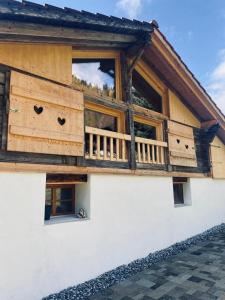 a wooden house with a balcony on the side of it at Chalet Bärgstäger in Lauterbrunnen