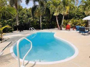 a swimming pool with blue water in a resort at Beach, Sand, Firepit and Pool in Clearwater Beach