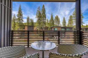 a patio with two chairs and a glass table at Powder Run - Newly Built Palisades 3 Bedroom Townhome - Minutes to Village in Olympic Valley