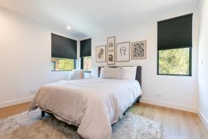 a white bedroom with a bed and two windows at Powder Run - Newly Built Palisades 3 Bedroom Townhome - Minutes to Village in Olympic Valley