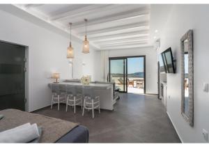 a living room with a kitchen and a dining room at Leuki Villa Milos in Adamas