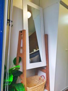 a bathroom with a mirror and a wooden ladder at AIR Residences-A Home to Remember by Luca's Cove in Manila