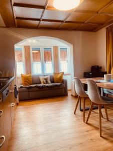 a living room with a couch and a table at Haus Heimatfrieden Mittenwald in Mittenwald
