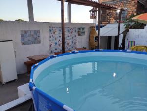 a large blue swimming pool in a building at Casa praia cabuçu - azul com piscina in Saubara