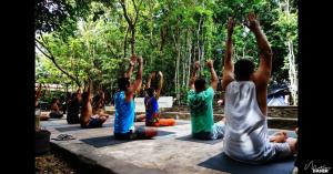 a group of people sitting in a yoga pose at Lagarto Na Banana Hostel in Pipa