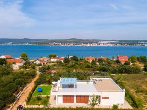 an aerial view of a house with a swimming pool at Santa Lucia - Villa&Boat in Turanj