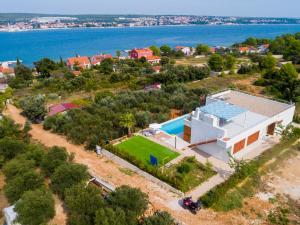 an aerial view of a house with a swimming pool at Santa Lucia - Villa&Boat in Turanj