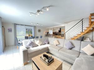 a living room with a couch and a table at Les Fontanelles, piscine privee in Canet-de-Salars