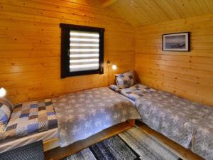 a bedroom with two beds in a log cabin at Holiday homes, Ustronie Morskie in Ustronie Morskie