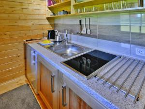 a kitchen with a sink and a counter top at Cottage in Ustronie Morskie near Aquapark in Ustronie Morskie