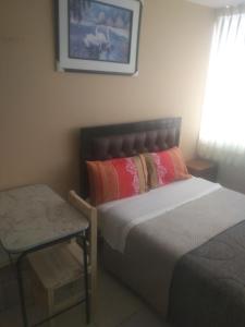 Кровать или кровати в номере Hostal Chachani