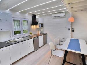 a kitchen with white cabinets and a table and chairs at Holiday resort, Grzybowo in Grzybowo