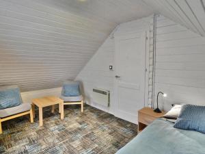 a bedroom with two chairs and a bed and a table at Holiday resort, Grzybowo in Grzybowo