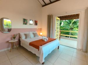 Ένα ή περισσότερα κρεβάτια σε δωμάτιο στο Canto do Mar - Apartamentos e Casa com vista pro Mar - Cumuruxatiba