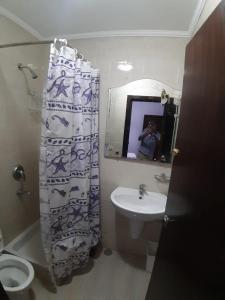 a person taking a picture of a bathroom with a shower curtain at Porto sokhna pyramids family only in Ain Sokhna