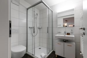 a bathroom with a shower and a toilet and a sink at Spirit Apartments - Suite #2 - Zentral - Parkplatz in Brienz