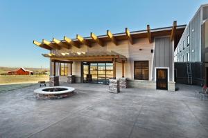a building with a fire pit in front of it at Shoshone Rose Casino & Hotel in Lander