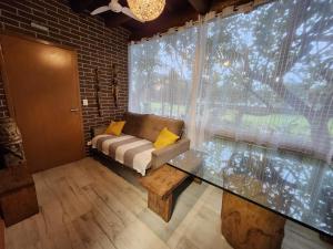 a living room with a couch and a glass table at Maresias Beach Home - Mata Azul in Maresias