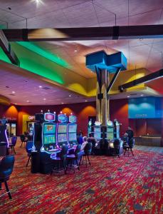 a casino with a bunch of slot machines in a room at Shoshone Rose Casino & Hotel in Lander