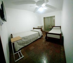 a room with two beds and a ceiling fan at HOTEL RESIDENCIAL CAMACHO in Cordoba