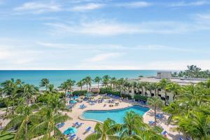 an aerial view of a resort with a pool and the ocean at Tides on Hollywood Beach in Hollywood