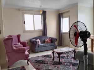 a living room with a couch and a fan at Giza Home in Cairo