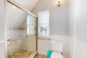 a bathroom with a toilet and a glass shower at Victorian by the Sea in Oak Bluffs +23 photos