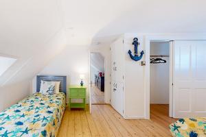 a bedroom with a bed and a door to a hallway at Victorian by the Sea in Oak Bluffs