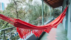 a red hammock hanging on a balcony at Centro Hostel Medellin in Medellín