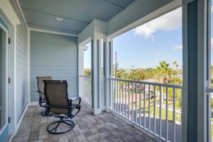 a rocking chair on a porch with a view of the ocean at Modern Redington Beach Townhome Steps to Beach! in St Pete Beach