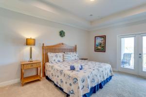 a bedroom with a bed and a lamp and a window at Modern Redington Beach Townhome Steps to Beach! in St Pete Beach