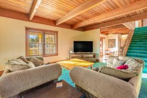 a living room with two couches and a television at Glacier-on-Ice in Kalispell