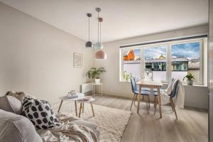 a living room with a couch and a table at New Couples Apartment In the Heart of Bergen in Bergen