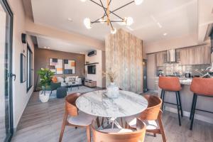 ein Esszimmer und eine Küche mit einem Tisch und Stühlen in der Unterkunft Breakfast Included at Regatta Living 802 in Los Prados