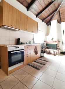 a kitchen with wooden cabinets and a stove at The best spot of Levidi village in Levidi