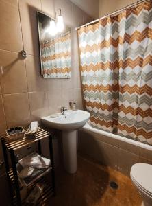 a bathroom with a sink and a shower curtain at The best spot of Levidi village in Levidi