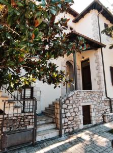 an orange tree in front of a house at The best spot of Levidi village in Levidi