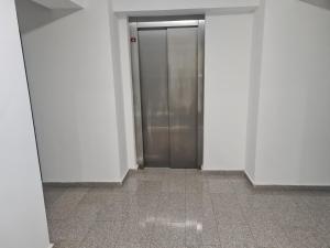 a hallway with a elevator in a building at Luxury Apartment Mall V in Bacău