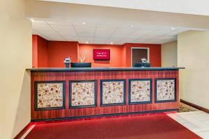 a waiting room with a counter and red walls at Red Roof Inn Springfield, OH in Springfield +28 photos