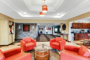 a living room with red chairs and a table at Red Roof Inn Springfield, OH in Springfield