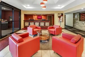a lobby with red chairs and a table at Red Roof Inn Springfield, OH in Springfield