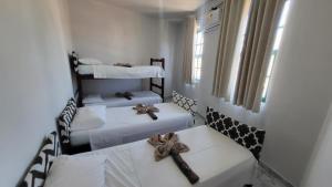 Postel nebo postele na pokoji v ubytování Tamboleiros Hotel & Hostel