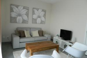 sala de estar con sofá y mesa de centro en Gite des Perrines, 