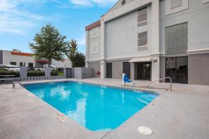 a swimming pool in front of a building at Red Roof Inn & Suites Newnan in Newnan