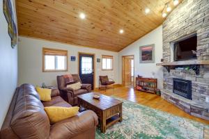 a living room with a couch and a fireplace at Peaceful Spruce Pine Cabin with Fire Pit! in Spruce Pine
