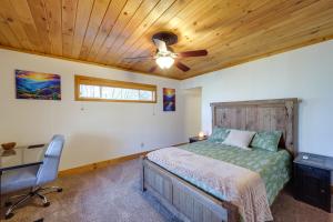 a bedroom with a bed and a ceiling fan at Peaceful Spruce Pine Cabin with Fire Pit! in Spruce Pine